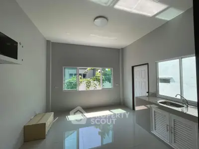 Bright modern kitchen with large windows and sleek design