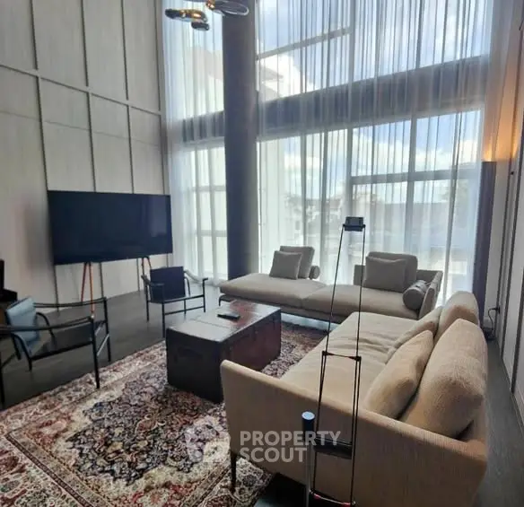 Luxurious living room with high ceilings and modern furniture