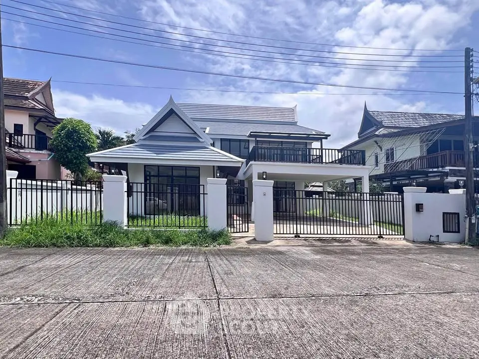 Charming two-story house with modern design and spacious front yard in a serene neighborhood.