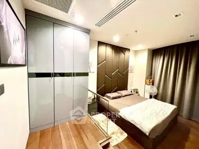 Modern bedroom with stylish decor and ample storage in a luxury apartment.