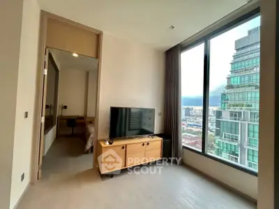 Modern living room with large window and city view in high-rise apartment