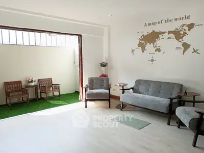 Spacious living room with modern furniture and garden view, perfect for relaxation.