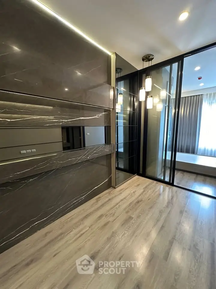 Luxurious modern interior with sleek marble walls and elegant lighting in a spacious living area.