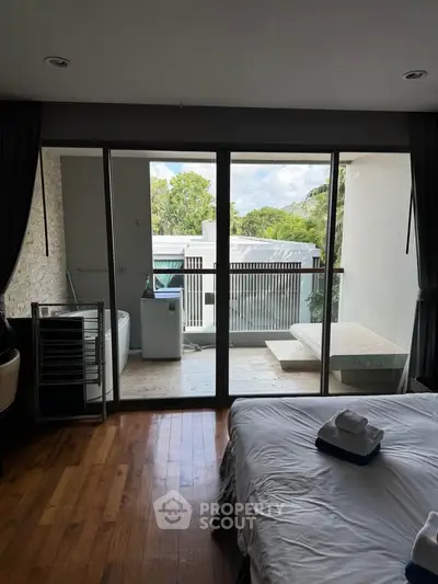 Spacious bedroom with balcony and scenic view in modern home