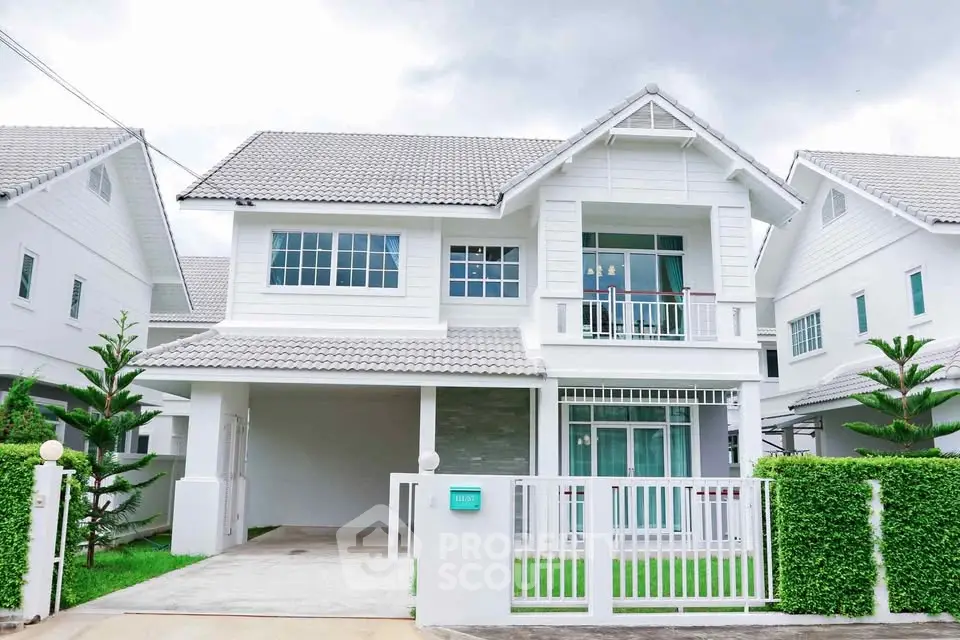 Charming two-story white house with modern design and lush green lawn