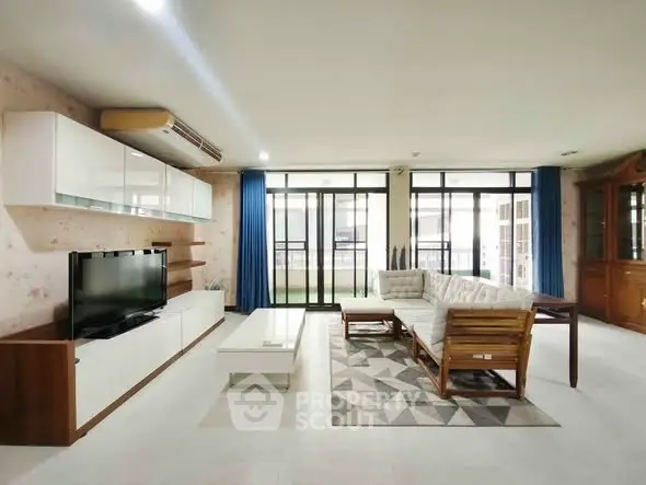 Spacious living room with modern furniture and large windows for natural light.