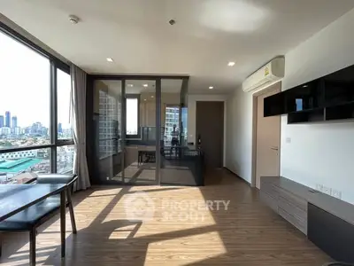 Spacious modern living room with large windows and city view