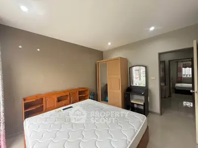 Spacious bedroom with modern furniture and natural light