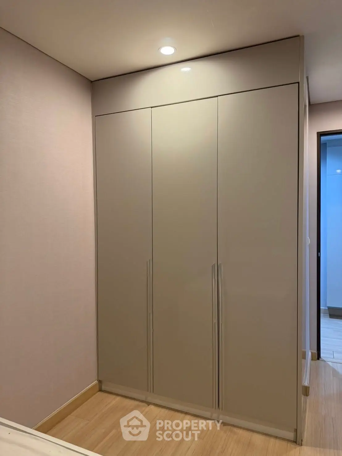Modern built-in wardrobe in a stylish bedroom with sleek design and ample storage space.