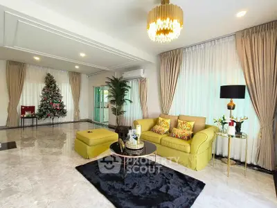 Luxurious living room with elegant decor and Christmas tree, featuring plush seating and ambient lighting.