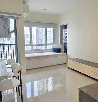 Bright modern living room with large windows and built-in seating, offering a cozy and inviting atmosphere.