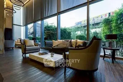 Luxurious living room with modern furniture and large windows offering a scenic view.