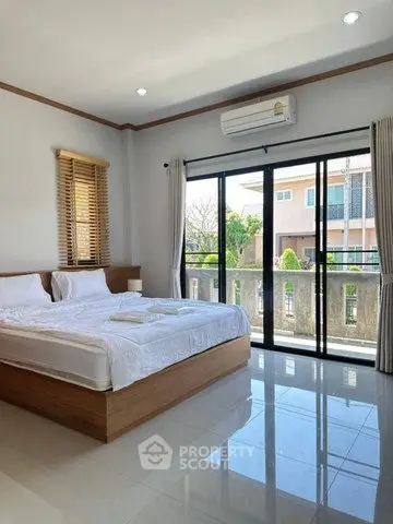 Spacious bedroom with large windows and modern decor