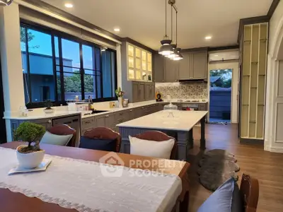 Luxurious open-layout kitchen with elegant dining area and modern appliances.