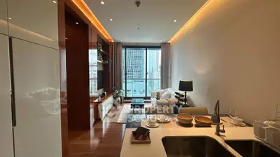Modern living room with city view, open kitchen layout, and elegant decor in a high-rise apartment.