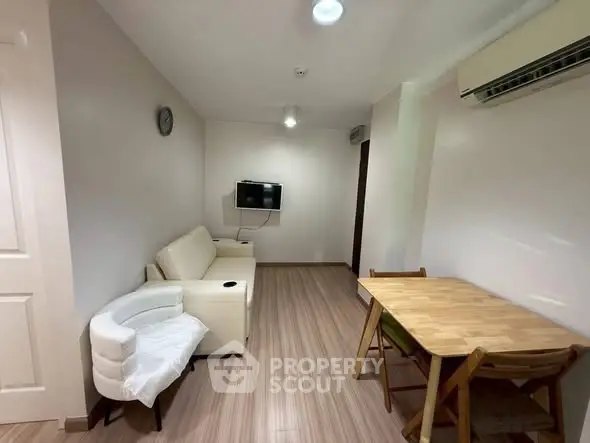 Cozy living room with modern furniture and air conditioning, perfect for relaxation and entertainment.