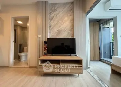 Modern living room with TV stand and open view to bedroom and bathroom