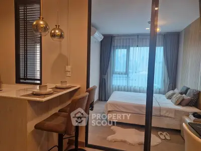 Modern studio apartment with cozy bedroom and stylish kitchen bar