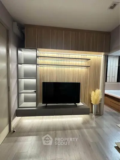 Modern living room with sleek TV unit and ambient lighting