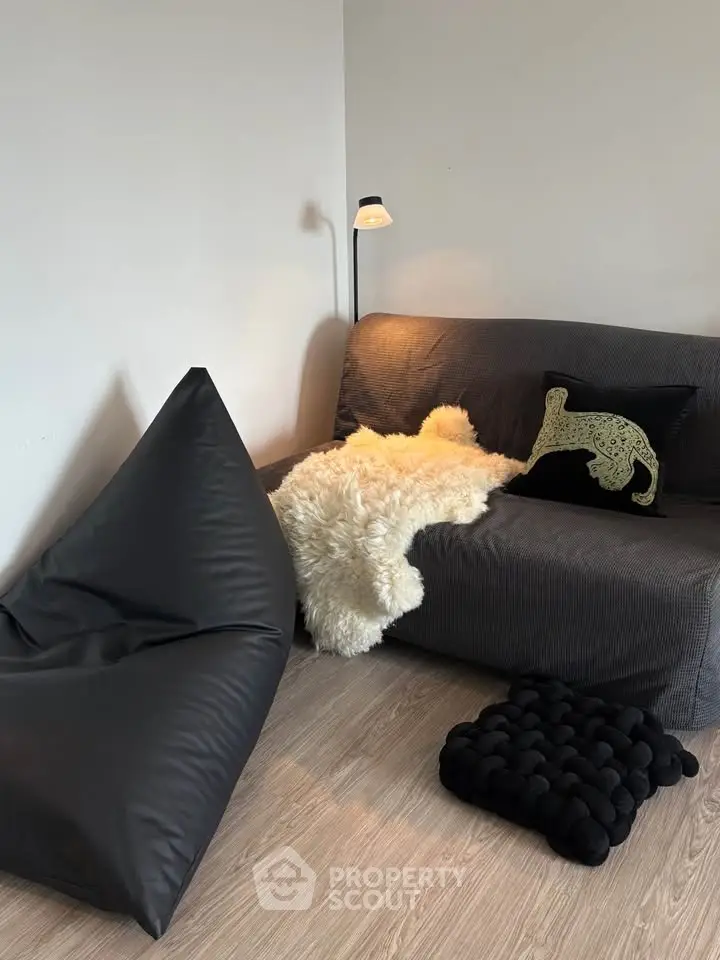 Cozy living room with modern bean bag, plush sofa, and stylish decor