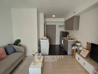 Modern living room with compact kitchen and washing machine, stylish decor