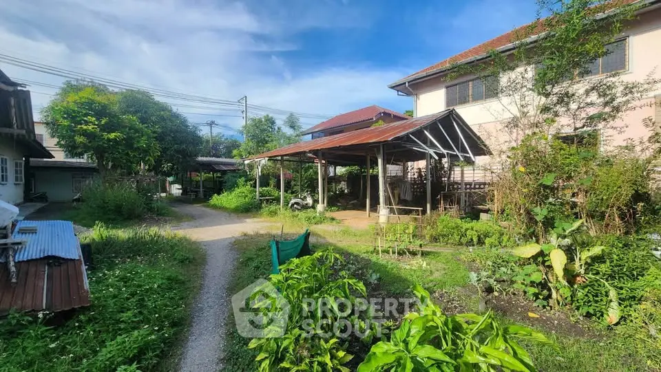 Charming garden view with lush greenery and rustic house exterior
