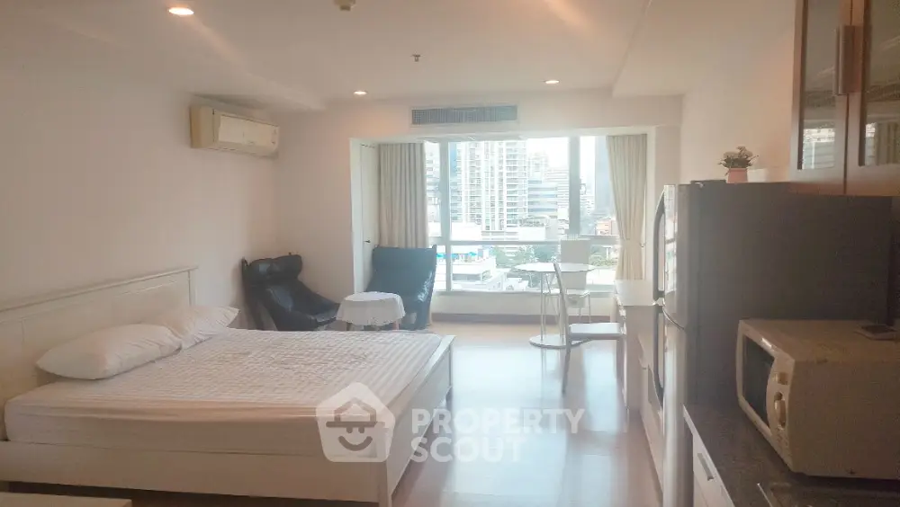 Spacious studio apartment with modern furnishings and city view