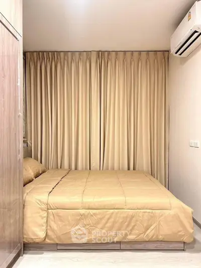 Cozy bedroom with elegant curtains and air conditioning, perfect for restful nights.