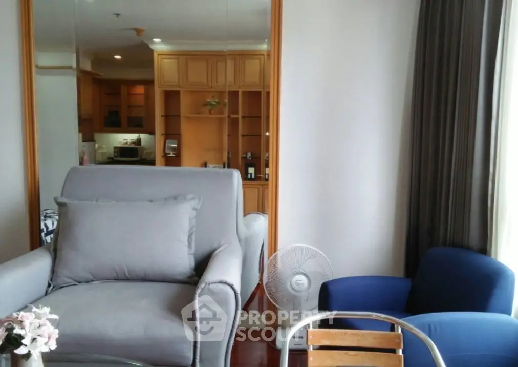 Cozy living room with modern furniture and natural light, perfect for relaxation.