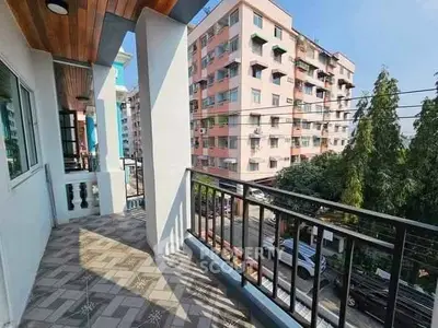 Spacious balcony with city view in modern apartment building