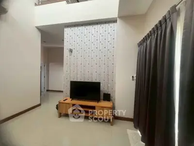 Spacious living room with high ceiling and modern decor