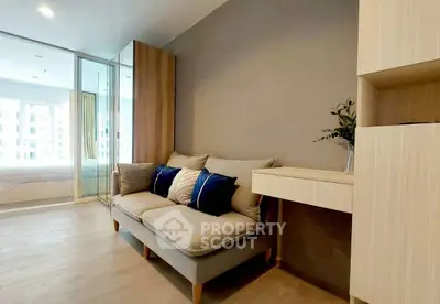 Modern living room with cozy sofa and stylish decor in bright apartment.
