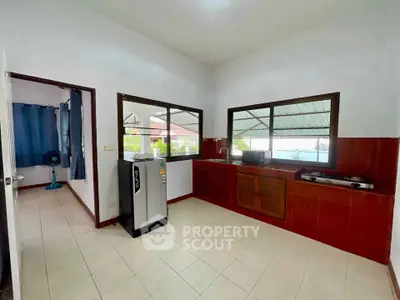 Spacious kitchen with modern appliances and large windows for natural light.