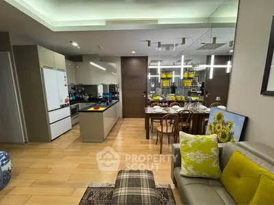 Modern open-layout kitchen and dining area with stylish decor and bright lighting.