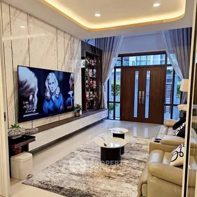 Luxurious living room with modern decor, large TV, and elegant marble accents.