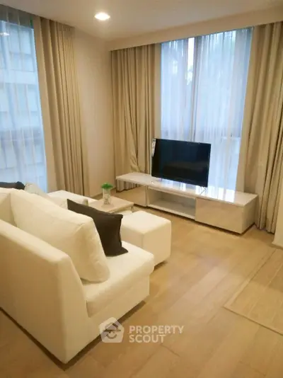 Stylish modern living room with cozy white sofa and sleek TV setup