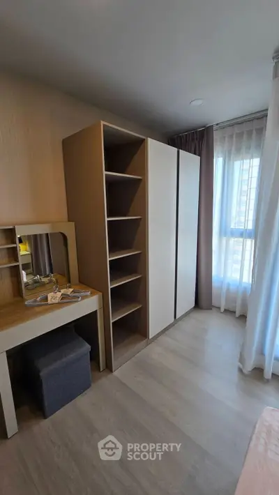 Modern bedroom with sleek wardrobe and vanity in bright apartment