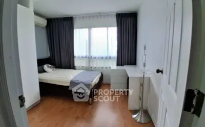 Cozy bedroom with modern decor and natural light, featuring a comfortable bed and stylish furnishings.