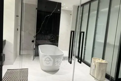 Luxurious modern bathroom with freestanding bathtub and sleek glass doors