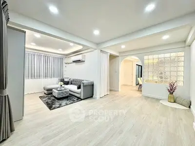 Spacious modern living room with elegant decor and ample natural light.
