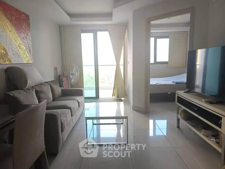 Modern living room with sleek furniture and balcony view in a stylish apartment.