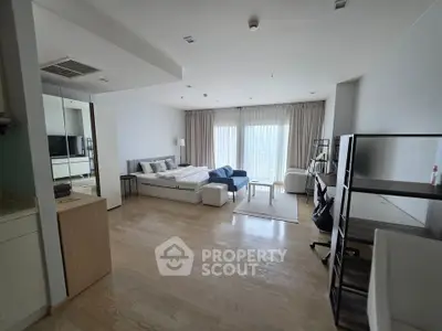Spacious modern bedroom with natural light and stylish furnishings