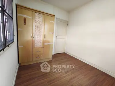 Spacious bedroom with wooden wardrobe and elegant flooring