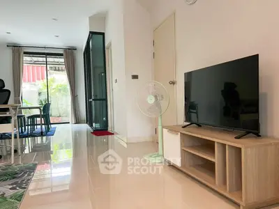 Modern living room with sleek TV stand and garden view, perfect for relaxation and entertainment.