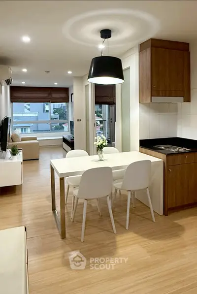 Modern open-plan living room with dining area and stylish lighting