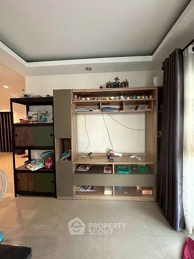 Spacious living room with modern shelving unit and natural light