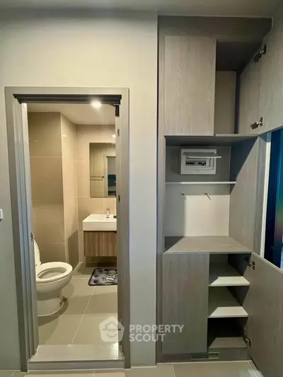 Modern bathroom with sleek design and ample storage space, featuring a stylish vanity and neutral tones.