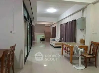 Spacious open-plan living area with modern furniture and natural light, perfect for family gatherings.