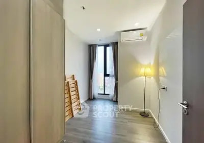 Bright and airy bedroom with modern flooring and large window view.