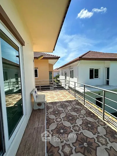Spacious balcony with stylish tiles and scenic view in modern residential building.